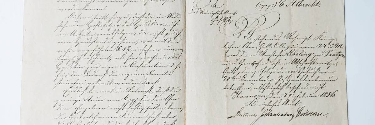 Aufgeschlagenes Buch, eine historosche Handschrift auf vergilbtem Papier ist zu sehen.