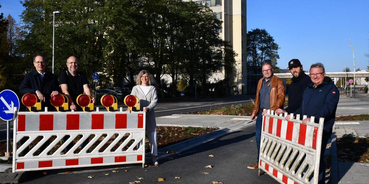 Wiedereröffnung der Markstraße. Die letzten Sperrbarken werden entfernt von Bürgermeister Jürgen Köhne, Berthold Gruben, Teamleiter Stadtplanung, Anja Gnad, Projektverantwortliche Team Tiefbau, Stadtrat Axel Grüning, David Knust, Firma Hagemann Sechs Personen stehen an einer Barke und öffnen diese. Dahinter sieht man eine Straße.