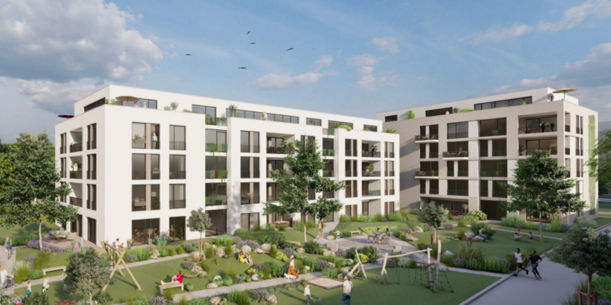 Ein Häuserensemle mit grünem Innenhof