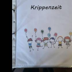 Es wird ein Beispiel aus einem Portfolioblatt gezeigt. Es ist das Deckblatt mit dem Titel- Meine Krippenzeit.