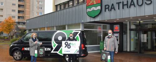 Maskenübergabe vor dem Rathaus mit Hannover 96-Bulli