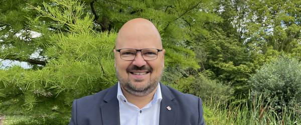 Portrait von Bürgermeister Kai Eggert im grünen Park der Sinne